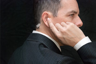 Security with an ear piece communicating with his team